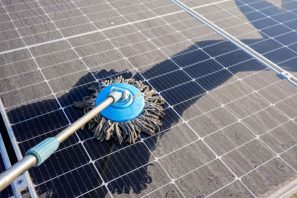 man-clean-up-solar-panels-that-are-dirty-with-dust-birds-droppings-min