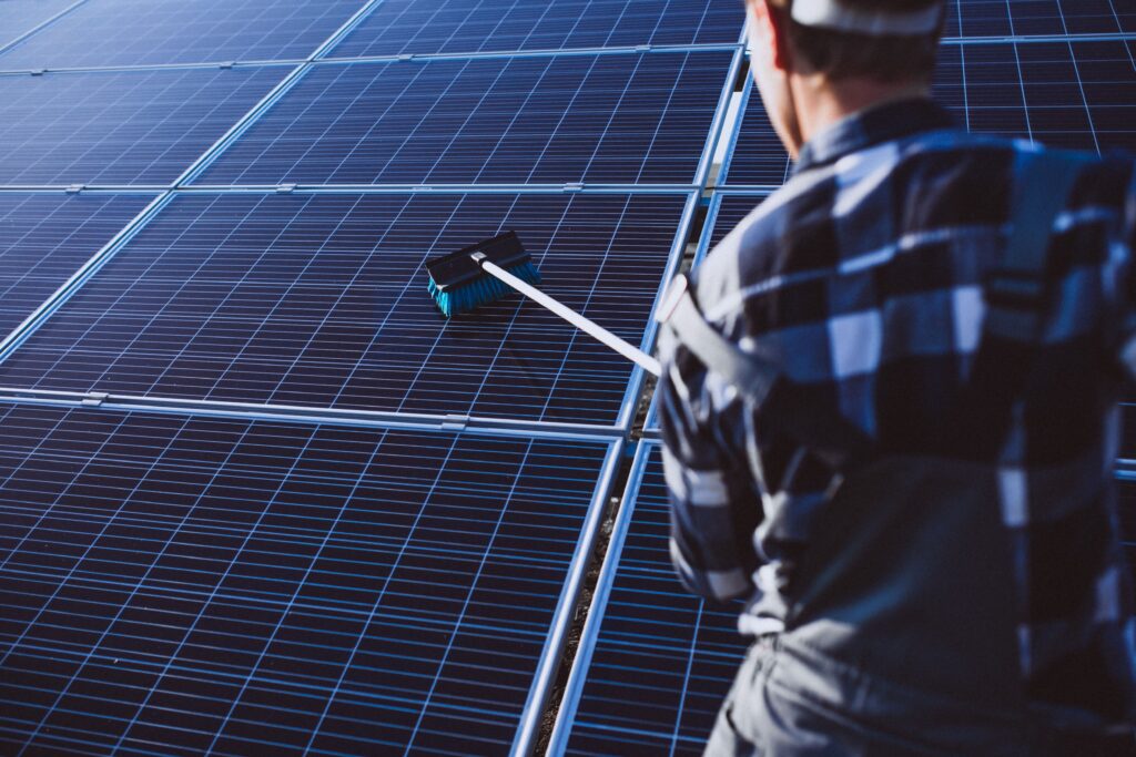 man-worker-firld-by-solar-panels-min