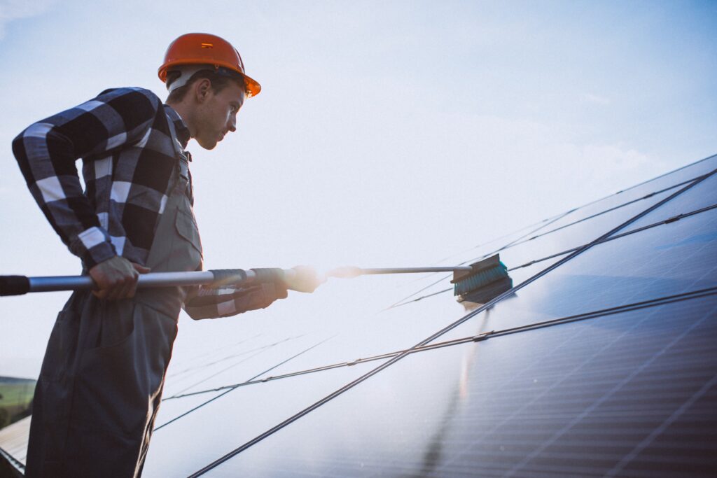 man-worker-firld-by-solar-panels-min
